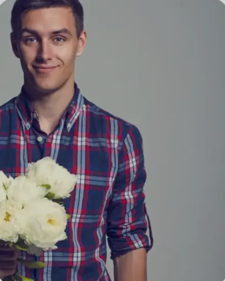 A shopper's own photo: a man in a plaid shirt holding white flowers
